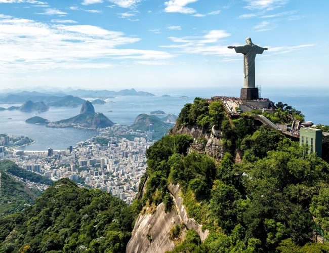 Aerial view of Christ Statue on Corcovado Hill overlooking skyline of Rio de Janeiro, Brazil. One of the world most popular landmark